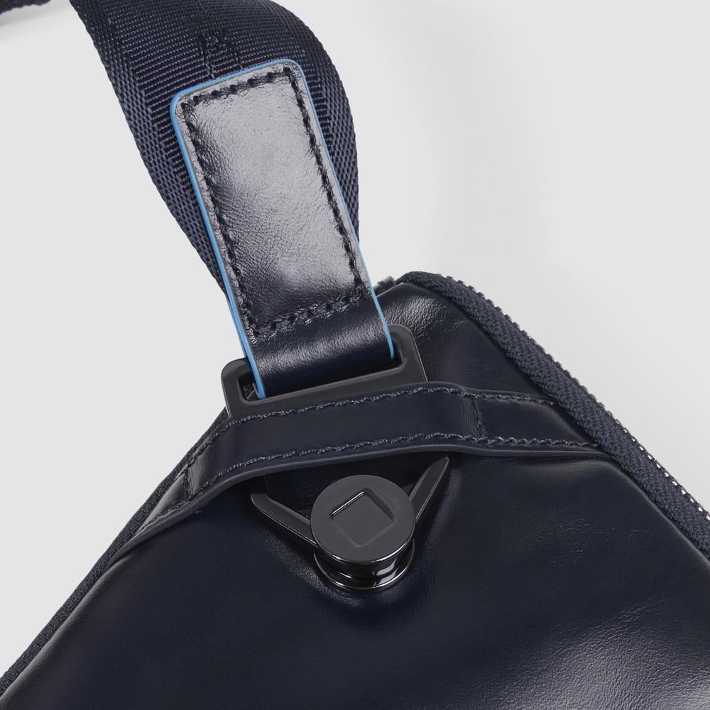 Flat expandable bum bag with repositionable shoulder strap attachments and pocket for airpods® PIQUADRO Blue