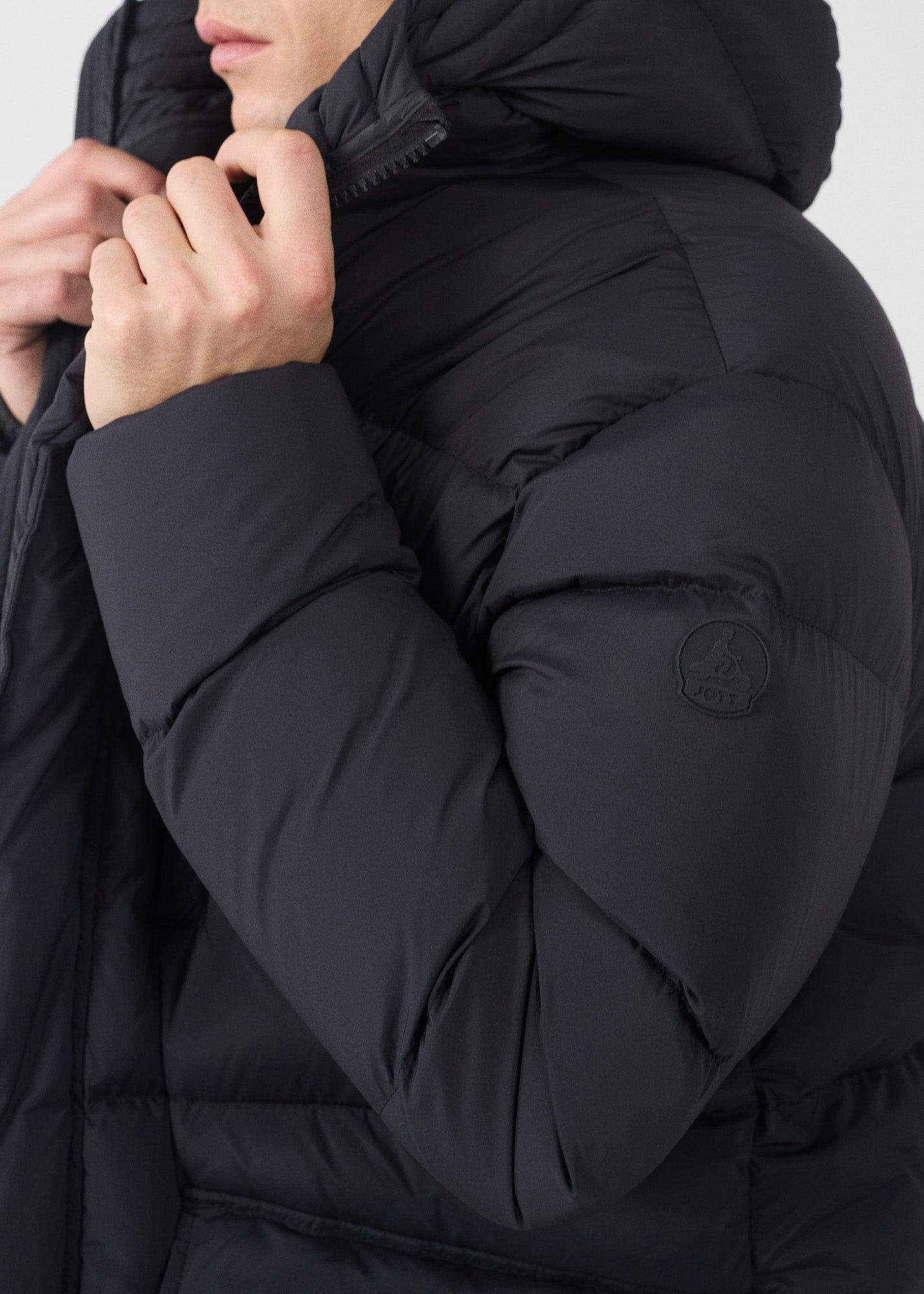 Mid-length stretch cold weather puffer coat by Scott. JOTT Black