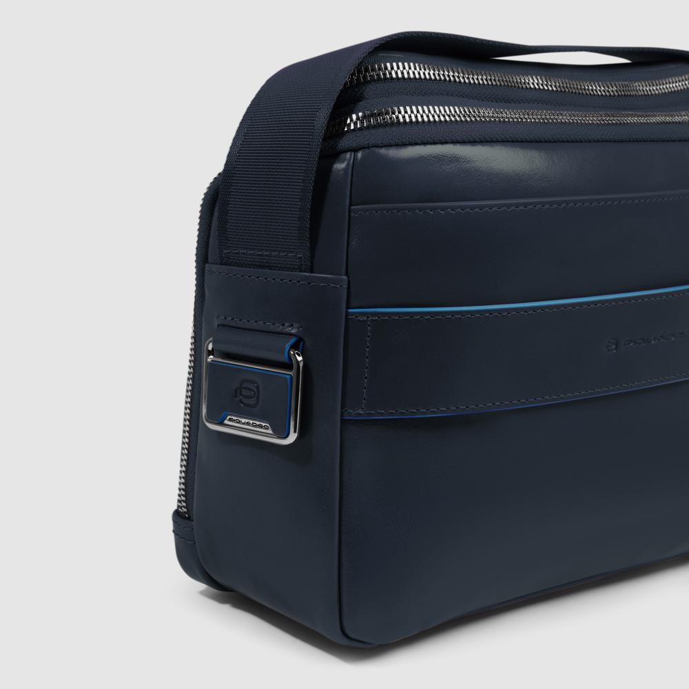 Customizable crossbody bag for iPad® mini with pockets for mouse and airpods and RFID protection. PIQUADRO Blue