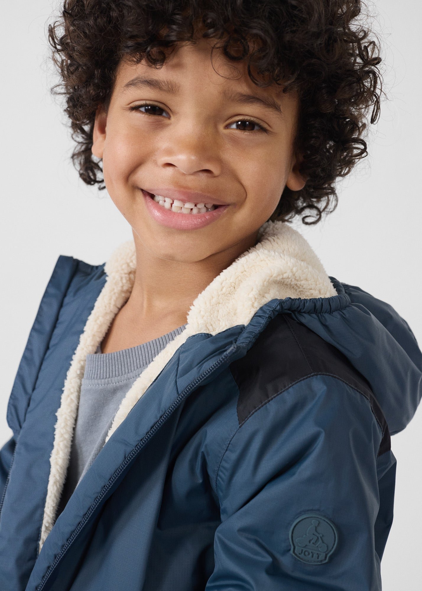 Children's hooded sherpa-lined raincoat in bluestone lag sherpa JOTT Blue