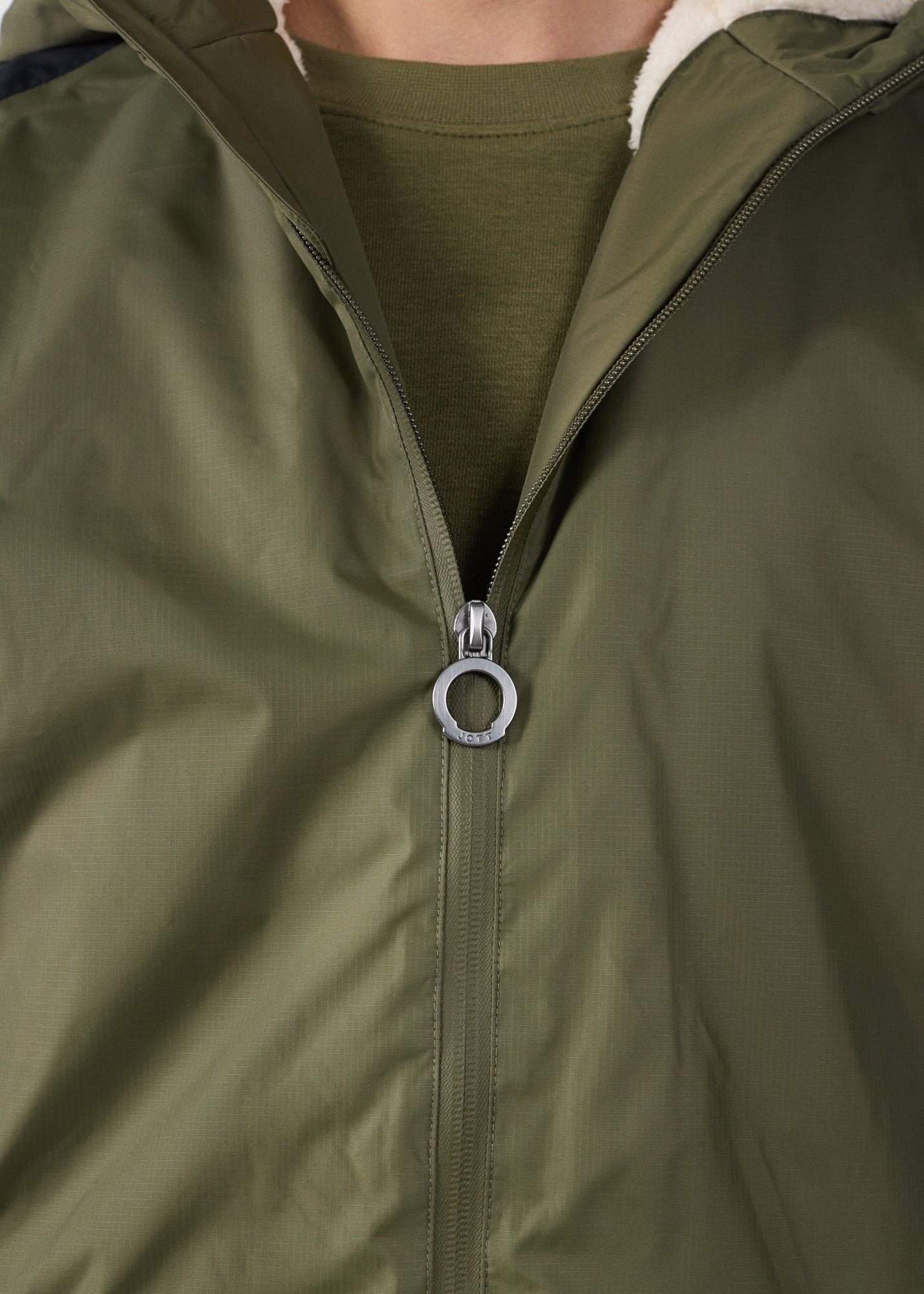 Sherpa-lined waterproof coat. JOTT Green