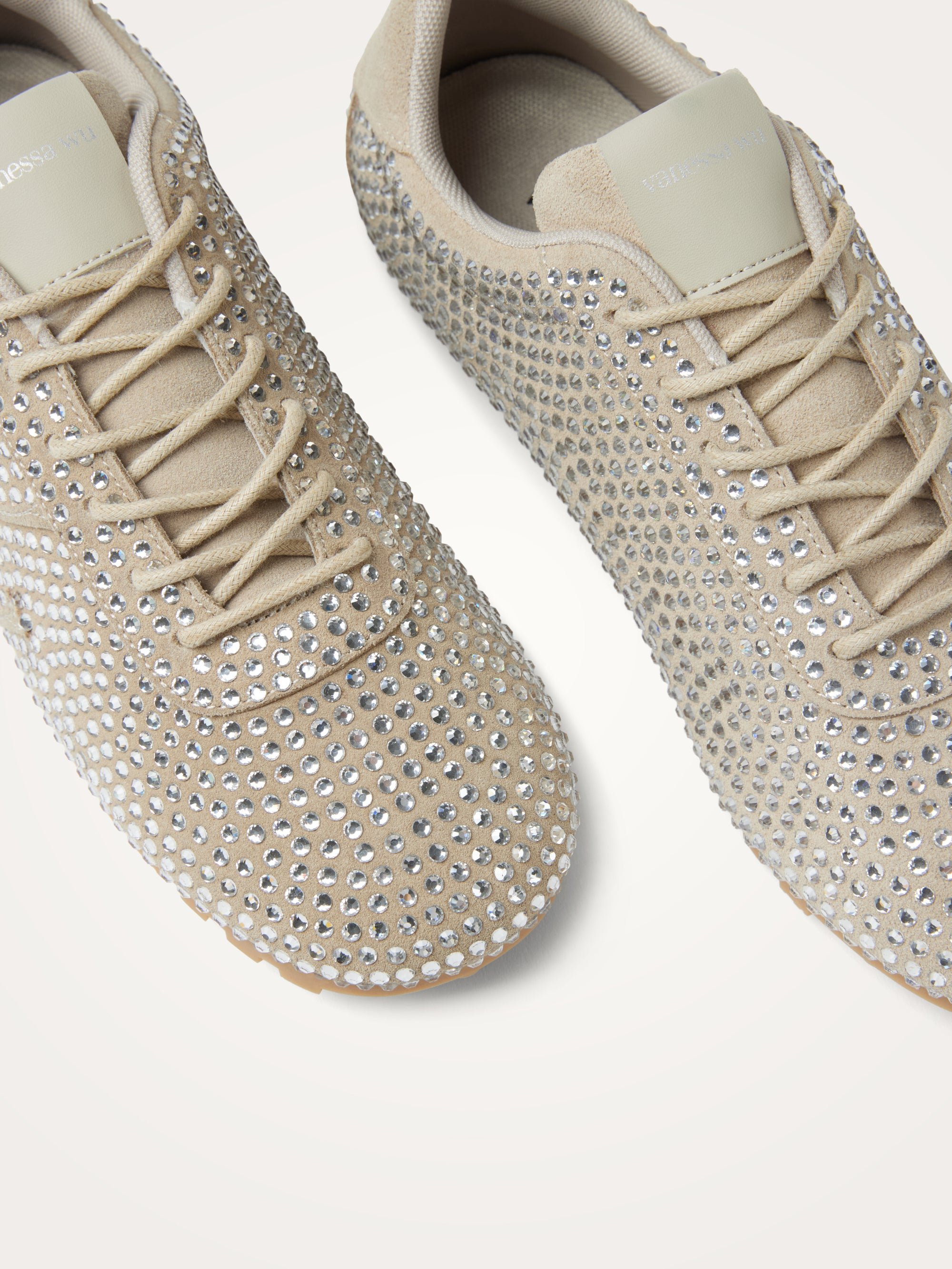 Monogram-embellished sneakers adorned with rhinestones on a serrated thin sole. VANESSA WU Beige